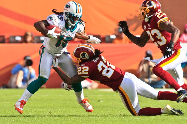 MIAMI GARDENS, FL - NOVEMBER 13:  Davone Bess #15 of the Miami Dolphins carries the ball and is tackled by Kevin Barnes #22 of the Washington Redskins during a NFL game at Sun Life Stadium on November 13, 2011 in Miami Gardens, Florida.  (Photo by Ronald C. Modra/Sports Imagery/Getty Images)