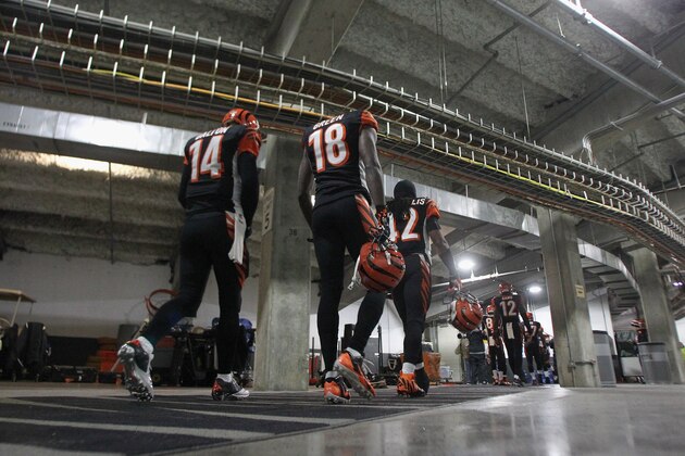 CINCINNATI, OH - JANUARY 05:  Andy Dalton #14 and A.J. Green #18 of the Cincinnati Bengals walk out to the field before the start of the AFC Wild Card playoff game between the San Diego Chargers and Cincinnati Bengals at Paul Brown Stadium on January 5, 2014 in Cincinnati, Ohio.  The Chargers defeated the Bengals 27-10. (Photo by John Grieshop/Getty Images)