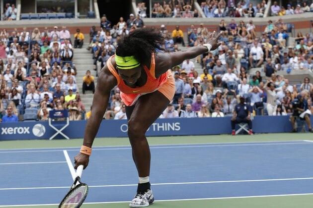 Serena Williams stumbles after missing a drop shot from Roberta Vinci, of Italy, during a semifinal match at the U.S. Open tennis tournament, Friday, Sept. 11, 2015, in New York. (AP Photo/Julio Cortez)