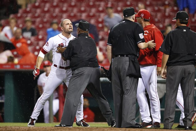 CINCINNATI, OH - SEPTEMBER 9: Joey Votto #19 of the Cincinnati Reds is restrained after being ejected by home plate umpire Bill Welke in the eighth inning of the game against the Pittsburgh Pirates at Great American Ball Park on September 9, 2015 in Cincinnati, Ohio. The Pirates defeated the Reds 5-4. (Photo by Joe Robbins/Getty Images)