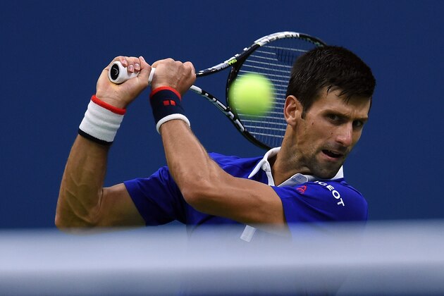 Novak Djokovic of Serbia returns the ball to Marin Cilic of Croatia during their 2015 US Open Men's singles semifinals match at the USTA Billie Jean King National Tennis Center in New York on September 11, 2015. AFP PHOTO/JEWEL SAMAD        (Photo credit should read JEWEL SAMAD/AFP/Getty Images)