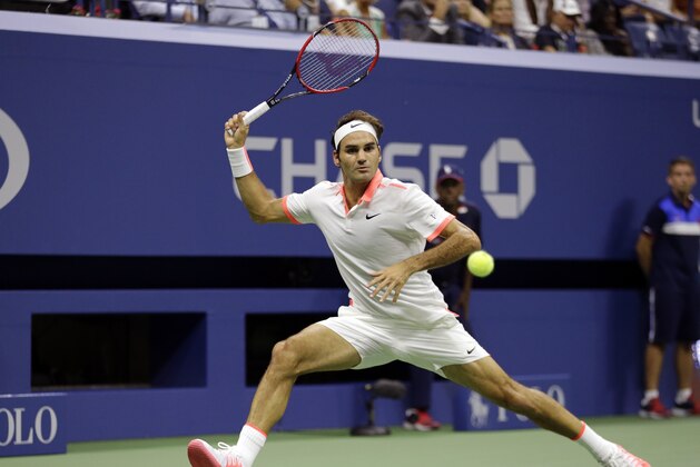Roger Federer, of Switzerland, returns a shot to Stan Wawrinka, of Switzerland, during a semifinal match at the U.S. Open tennis tournament, Friday, Sept. 11, 2015, in New York. (AP Photo/David Goldman)