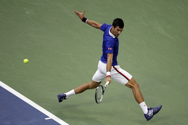 Novak Djokovic, of Serbia, returns a shot to Marin Cilic, of Croatia, during a semifinal match at the U.S. Open tennis tournament, Friday, Sept. 11, 2015, in New York. (AP Photo/Bill Kostroun)
