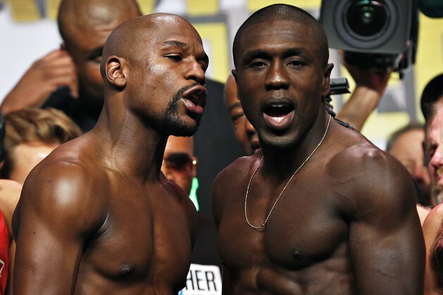 Floyd Mayweather Jr., left, and Andre Berto pose for photographers during a weigh-in Friday, Sept. 11, 2015, in Las Vegas. The two are scheduled to fight in a welterweight title bout Saturday in Las Vegas. (AP Photo/John Locher)
