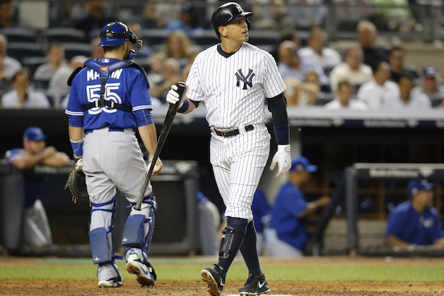 New York Yankees designated hitter Alex Rodriguez reacts after striking out near Toronto Blue Jays catcher Russell Martin (55) in the third inning of a baseball game at Yankee Stadium in New York, Friday, Sept. 11, 2015. (AP Photo/Kathy Willens)
