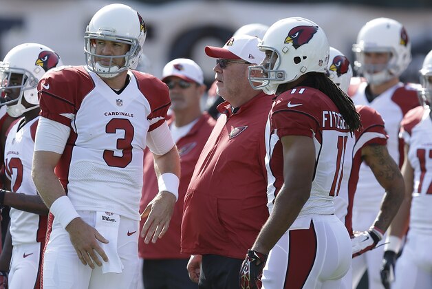 Arizona Cardinals quarterback Carson Palmer (3) talks with wide receiver Larry Fitzgerald (11) and head coach Bruce Arians before an NFL preseason football game against the Oakland Raiders in Oakland, Calif., Sunday, Aug. 30, 2015. (AP Photo/Ben Margot)