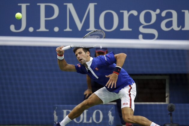Novak Djokovic, of Serbia, returns a shot to Marin Cilic, of Croatia, during a semifinal match at the U.S. Open tennis tournament, Friday, Sept. 11, 2015, in New York. (AP Photo/David Goldman)