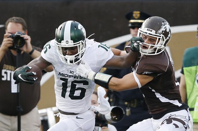 KALAMAZOO, MI - SEPTEMBER 4: Aaron Burbridge #16 of the Michigan State Spartans fights for yardage after a 56-yard reception against Justin Tranquill #2 of the Western Michigan Broncos in the first half at Waldo Stadium on September 4, 2015 in Kalamazoo, Michigan. (Photo by Joe Robbins/Getty Images)
