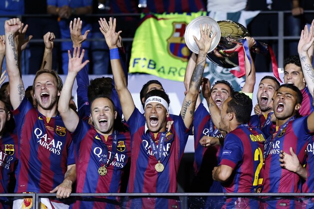FILE - In this Saturday June 6, 2015 file photo, Barcelona players celebrate with the trophy after winning the Champions League final soccer match against Juventus Turin at the Olympic stadium in Berlin. Barcelona won the match 3-1. (AP Photo/Luca Bruno, File)
