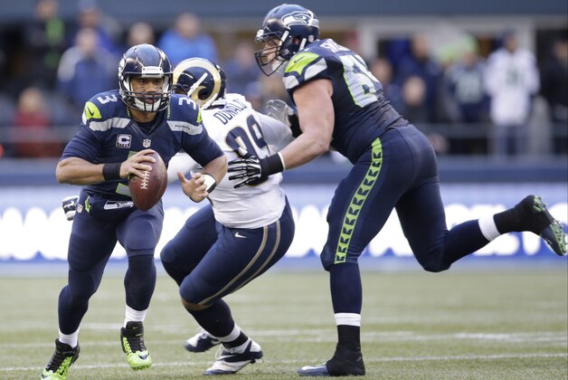 Seattle Seahawks quarterback Russell Wilson (3) looks to pass the ball against the St. Louis Rams in the second half of an NFL football game, Sunday, Dec. 28, 2014, in Seattle. (AP Photo/Scott Eklund)