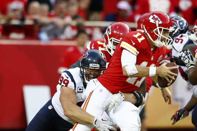 Kansas City Chiefs quarterback Alex Smith (11) is tackled by Houston Texans defensive end J.J. Watt (99) during an NFL game at Arrowhead Stadium in Kansas City, MO., Sunday, Oct. 20, 2013. (AP Photo/TUSP, Jay Biggerstaff)