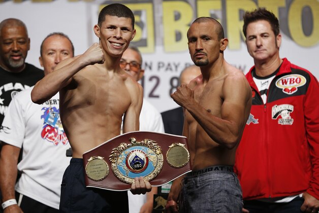 Roman Martinez, left, and Orlando Salido pose during their weigh-in Friday, Sept. 11, 2015, in Las Vegas. The two are scheduled to fight in a junior lightweight title bout Saturday in Las Vegas. (AP Photo/John Locher)