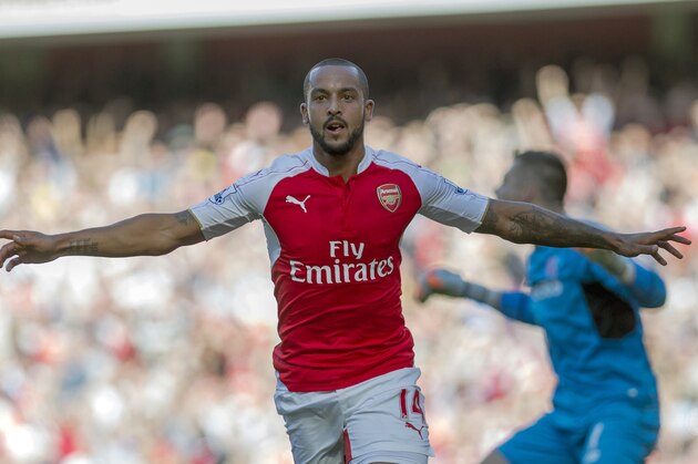 Arsenal's Theo Walcott celebrates after scoring against Stoke City, during their English Premier League soccer match between Arsenal and Stoke City, at Emirates Stadium, in London, Saturday, Sept. 12, 2015. (AP Photo/Bogdan Maran)