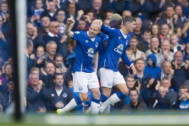 Everton's Steven Naismith, left, is congratulated by teammate John Stones after scoring his first goal against Chelsea during the English Premier League soccer match between Everton and Chelsea at Goodison Park Stadium, Liverpool, England, Saturday Sept. 12, 2015. (AP Photo/Jon Super)
