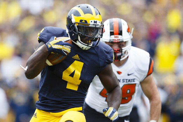 Sep 12, 2015; Ann Arbor, MI, USA; Michigan Wolverines running back De'Veon Smith (4) rushes for a touchdown in the second quarter against the Oregon State Beavers at Michigan Stadium. Mandatory Credit: Rick Osentoski-USA TODAY Sports