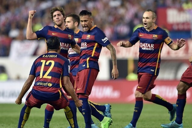 Barcelona's Brazilian forward Neymar (C) celebrates with teammates after scoring during the Spanish league football match Club Atletico de Madrid vs FC Barcelona at the Vicente Calderon stadium in Madrid on September 12, 2015.   AFP PHOTO/ GERARD JULIEN        (Photo credit should read GERARD JULIEN/AFP/Getty Images)
