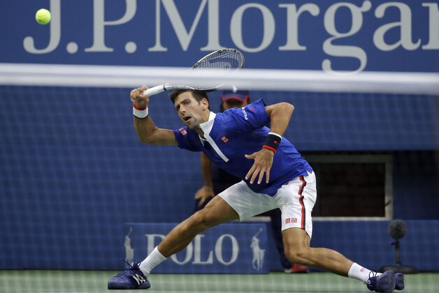 Novak Djokovic, of Serbia, returns a shot to Marin Cilic, of Croatia, during a semifinal match at the U.S. Open tennis tournament, Friday, Sept. 11, 2015, in New York. (AP Photo/David Goldman)