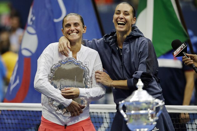 Roberta Vinci, of Italy, left, and Flavia Pennetta, of Italy, react during the trophy ceremony for the women's championship match of the U.S. Open tennis tournament, Saturday, Sept. 12, 2015, in New York. Pennetta beat Vinci in straight sets. (AP Photo/David Goldman)