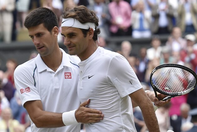 Novak Djokovic of Serbia, left, shakes hands with Roger Federer of Switzerland after winning the men's singles final at the All England Lawn Tennis Championships in Wimbledon, London, Sunday July 12, 2015. Djokovic won the match 7-6, 6-7, 6-4, 6-3.  (Toby Melville/Pool Photo via AP)