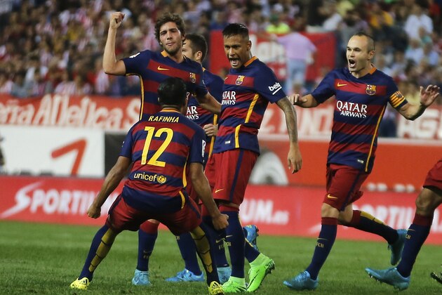 Barcelona’s Neymar, centre, celebrates after scoring during a Spanish La Liga soccer match between Atletico Madrid and Barcelona at the Vicente Calderon stadium in Madrid, Spain, Saturday Sept. 12, 2015. (AP Photo/Paul White)