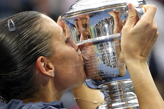 Flavia Pennetta, of Italy, kisses the championship trophy after beating Roberta Vinci, of Italy, in the women's championship match of the U.S. Open tennis tournament, Saturday, Sept. 12, 2015, in New York. (AP Photo/Julio Cortez)