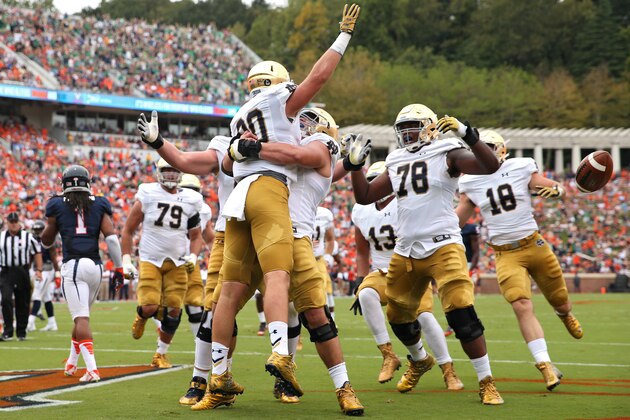 CHARLOTTESVILLE, VA - SEPTEMBER 12: Tight end Durham Smythe #80 of the Notre Dame Fighting Irish celebrates with teammates after scoring a touchdown on a fake field goal attempt in the first quarter against the Virginia Cavaliers at Scott Stadium on September 12, 2015 in Charlottesville, Virginia. (Photo by Patrick Smith/Getty Images)