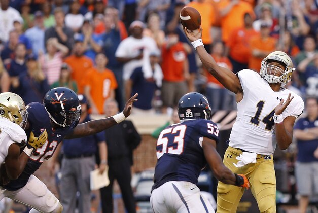Sep 12, 2015; Charlottesville, VA, USA; Notre Dame Fighting Irish quarterback DeShone Kizer (14) throws the game-winning touchdown pass over Virginia Cavaliers linebacker Micah Kiser (53) with twelve seconds left in the fourth quarter at Scott Stadium. The Fighting Irish won 34-27. Mandatory Credit: Geoff Burke-USA TODAY Sports