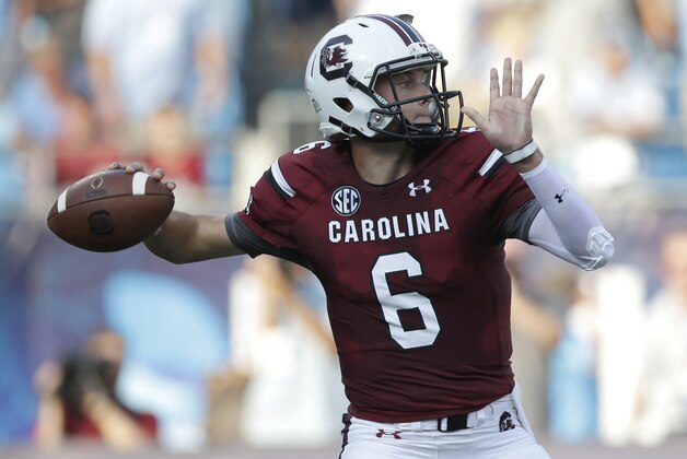 South Carolina's Connor Mitch looks to pass against North Carolina in the first half of an NCAA college football game in Charlotte, N.C., Thursday, Sept. 3, 2015. (AP Photo/Chuck Burton)