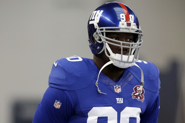 New York Giants defensive end Jason Pierre-Paul stands on the field during warm ups before an NFL football game against the Dallas Cowboys, Sunday, Oct., 19, 2014, in Arlington, Texas. (AP Photo/LM Otero)