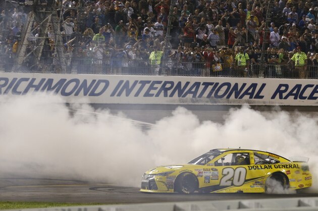 Matt Kenseth (20) does a burnout after winning the NASCAR Sprint Cup auto race at Richmond International Raceway in Richmond, Va., Saturday, Sept. 12, 2015. (AP Photo/Steve Helber)