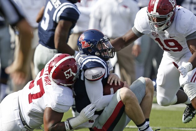 Mississippi quarterback Bo Wallace (14) is sacked by Alabama linebacker D.J. Pettway (57) as teammate Reggie Ragland (19) comes to help during the first half of an NCAA college football game in Oxford, Miss., Saturday, Oct. 4, 2014. No. 11 Mississippi won 23-17. (AP Photo/Rogelio V. Solis)