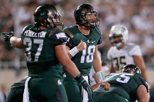 EAST LANSING, MI - SEPTEMBER 12:  Connor Cook #18 of the Michigan State Spartans yells to a teammate against the Oregon Ducks during their game at Spartan Stadium on September 12, 2015 in East Lansing, Michigan.  (Photo by Streeter Lecka/Getty Images)
