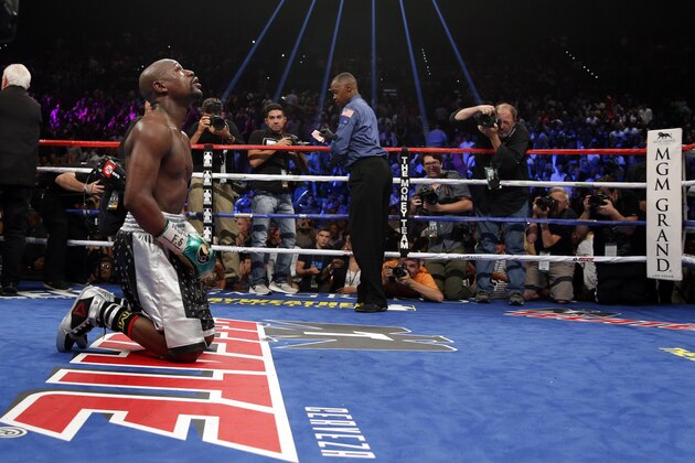 Floyd Mayweather Jr. kneels at the end of his welterweight title boxing bout against Andre Berto on Saturday, Sept. 12, 2015, in Las Vegas. (AP Photo/John Locher)