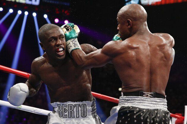 Floyd Mayweather Jr., right, hits Andre Berto during their welterweight title fight Saturday, Sept. 12, 2015, in Las Vegas. (AP Photo/John Locher)