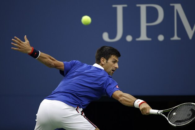 Novak Djokovic, of Serbia, returns a shot to Marin Cilic, of Croatia, during a semifinal match at the U.S. Open tennis tournament, Friday, Sept. 11, 2015, in New York. (AP Photo/Seth Wenig)