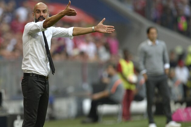 Bayern Munich's Spanish headcoach Pep Guardiola gestures during the German first division Bundesliga football match Bayern Munich vs Bayer 04 Leverkusen in Munich, southern Germany, on August 29, 2015.  AFP PHOTO / CHRISTOF STACHE

RESTRICTIONS: DURING MATCH TIME: DFL RULES TO LIMIT THE ONLINE USAGE TO 15 PICTURES PER MATCH AND FORBID IMAGE SEQUENCES TO SIMULATE VIDEO. 
== RESTRICTED TO EDITORIAL USE ==
FOR FURTHER QUERIES PLEASE CONTACT DFL DIRECTLY AT + 49 69 650050.        (Photo credit should read CHRISTOF STACHE/AFP/Getty Images)