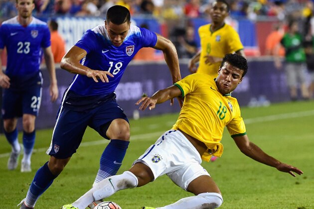 FOXBORO, MA - SEPTEMBER 08:  Bobby Wood #18 of the United States tackles Rafinha #18 of Brazil during an international friendly at Gillette Stadium on September 8, 2015 in Foxboro, Massachusetts.  (Photo by Billie Weiss/Getty Images)