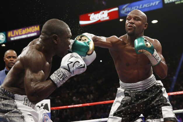Floyd Mayweather Jr., right, fights Andre Berto during their welterweight title bout Saturday, Sept. 12, 2015, in Las Vegas. (AP Photo/Steve Marcus)