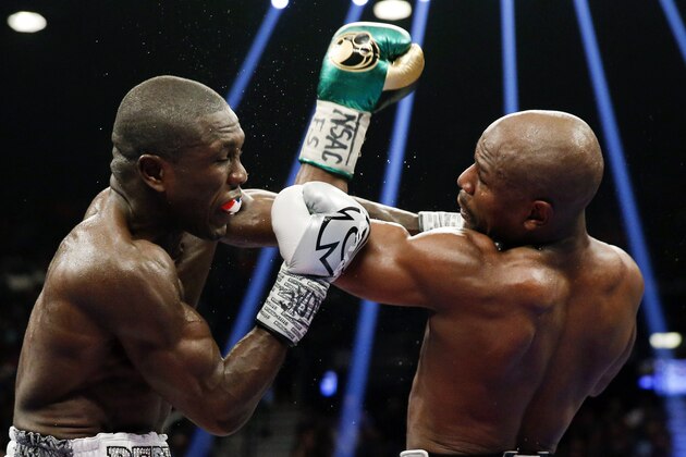 Floyd Mayweather Jr., right, hits Andre Berto during their welterweight title boxing bout Saturday, Sept. 12, 2015, in Las Vegas. (AP Photo/Steve Marcus)