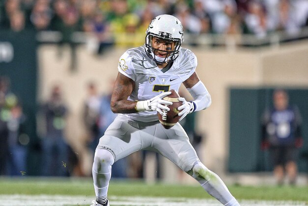 Sep 12, 2015; East Lansing, MI, USA; Oregon Ducks quarterback Vernon Adams Jr. (3) looks to run the ball against the Michigan State Spartans during the 1st half of a game at Spartan Stadium. Mandatory Credit: Mike Carter-USA TODAY Sports