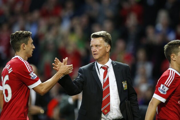 Manchester United's manager Louis van Gaal greets Matteo Darmian after the English Premier League soccer match between Manchester United and Liverpool at Old Trafford Stadium, Manchester, England, Saturday, Sept. 12, 2015.  United won the match 3-1. (AP Photo/Jon Super)