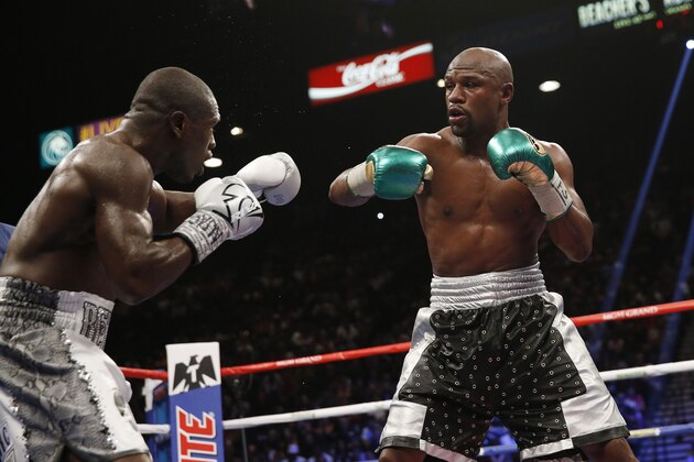 Floyd Mayweather Jr., right, fights Andre Berto during their welterweight title bout Saturday, Sept. 12, 2015, in Las Vegas. (AP Photo/Steve Marcus)
