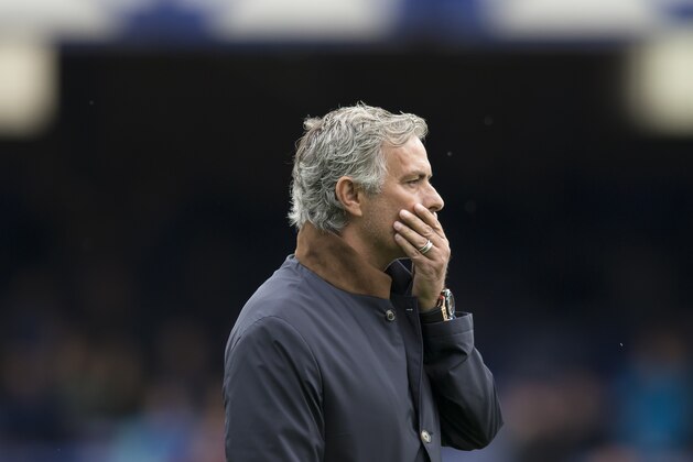 Chelsea manager Jose Mourinho wipes his face as he stands on the pitch before the English Premier League soccer match between Everton and Chelsea at Goodison Park Stadium, Liverpool, England, Saturday Sept. 12, 2015. (AP Photo/Jon Super)