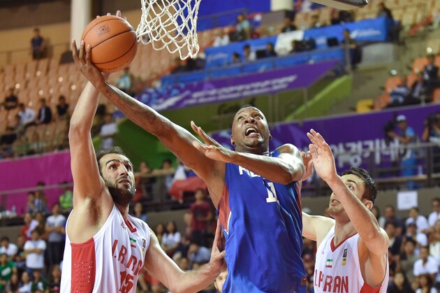 Basketball player Marcus Eugene Douthit (C) of the Philippines competes for the ball with Iraqi players during the men's basketball men preliminary round group E at the Incheon International Velodrome during the 17th Asian Games in Incheon on September 25, 2014.   AFP PHOTO / Bay ISMOYO        (Photo credit should read BAY ISMOYO/AFP/Getty Images)
