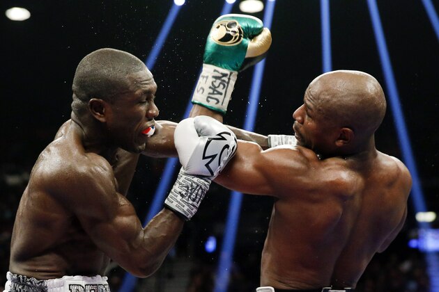Floyd Mayweather Jr., right, hits Andre Berto during their welterweight title boxing bout Saturday, Sept. 12, 2015, in Las Vegas. (AP Photo/Steve Marcus)