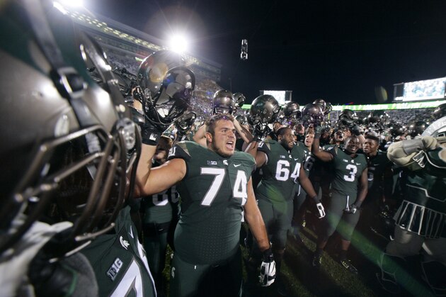 Michigan State players, including Jack Conklin (74), Brandon Clemons (64) and L.J. Scott (3), celebrate following a 31-28 win over Oregon in an NCAA college football game, Saturday, Sept. 12, 2015, in East Lansing, Mich. (AP Photo/Al Goldis)