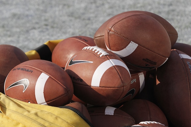 A bag of footballs sits on the field before the start of the Oklahoma-Kansas State NCAA college football game in Norman, Okla., Saturday, Sept. 22, 2012. (AP Photo/Sue Ogrocki)