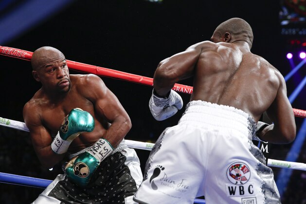 Floyd Mayweather Jr. and Andre Berto during their welterweight title fight Saturday, Sept. 12, 2015, in Las Vegas. (AP Photo/John Locher)