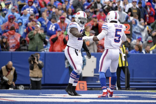 Buffalo Bills running back Boobie Dixon, left, celebrates his touchdown with quarterback Tyrod Taylor (5) during the second half of an NFL football game on Sunday, Sept. 13, 2015, in Orchard Park, N.Y. (AP Photo/Gary Wiepert)