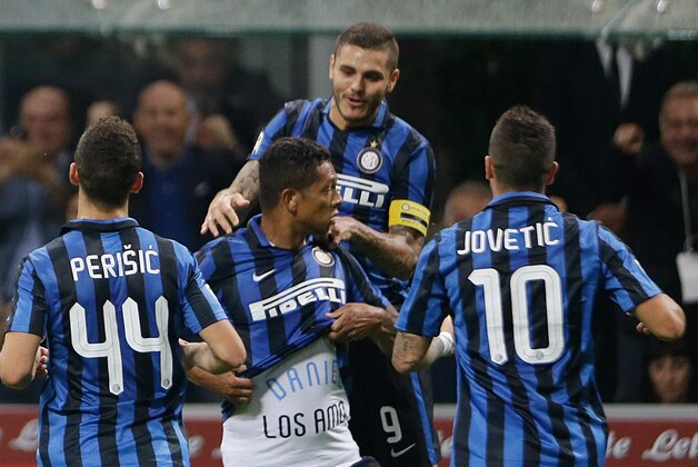 Inter Milan's Fredy Guarin, center, celebrates with his teammates Mauro Icardi, top, Ivan Perisic, left, and Stevan Jovetic after scoring during a Serie A soccer match between Inter Milan and AC Milan, at the San Siro stadium in Milan, Italy, Sunday, Sept. 13, 2015. (AP Photo/Luca Bruno)